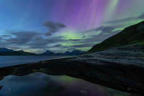 Northern lights at dawn over Sørfolda Fjord near Kjerringøy between Bodø and Sørfold in Norway