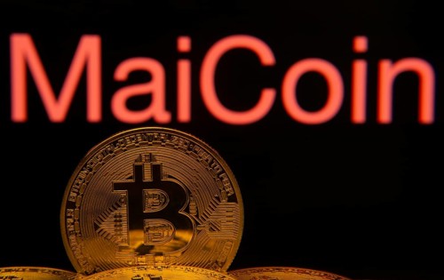 Dhaka, Bangladesh- 03 Sep 2025: Close-up of Bitcoin coins with the MaiCoin logo visible on a screen