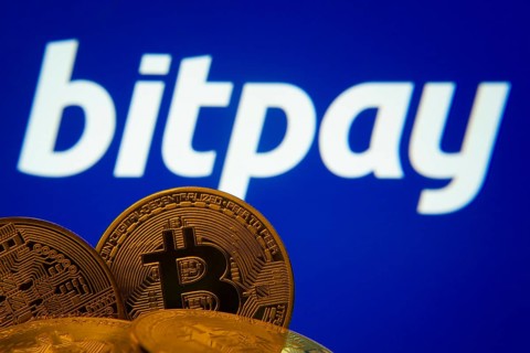 Dhaka, Bangladesh- 26 Aug 2025: Close-up of Bitcoin coins with the bitpay logo visible on a screen