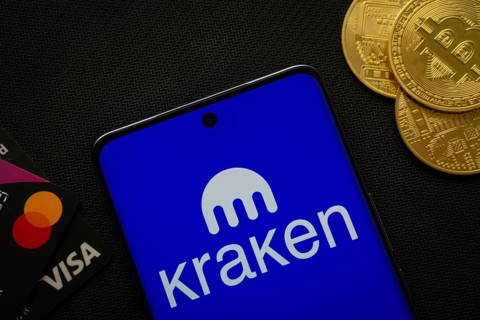 Dhaka, Bangladesh- 26 Aug 2025: Smartphone displaying Kraken logo surrounded by Bitcoin coins and