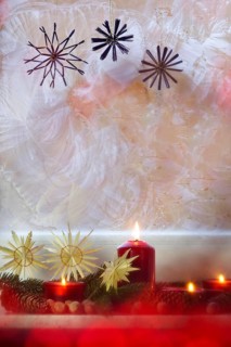 Christmassy decorated iced window, candle light, straw stars, Germany