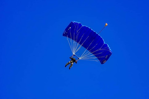 Skydivers during an aerial acrobatic performance as part of an air show at the Fliegerbergfest of