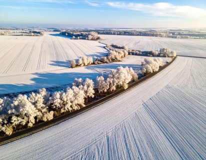Bird Eye Perspective of Frost Covered Farmland. Seasonal Agricultural Scenery, winter and autumn