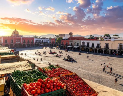 Traditional Mexican plaza with crates of peppers, onions, and tomatoes, economic prosperity in