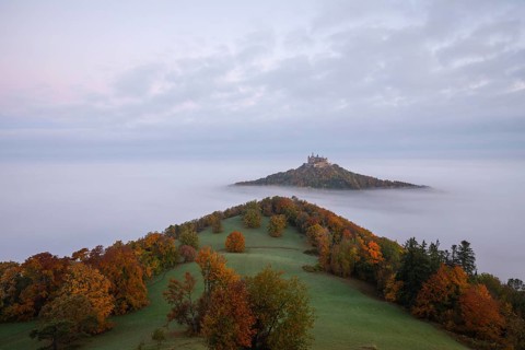 Hohenzollern Castle in a sea of fog at sunrise, autumn in the Swabian Jura