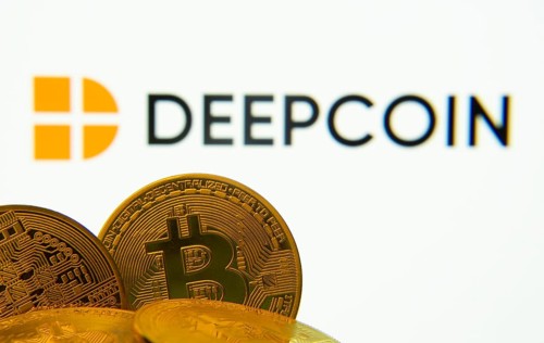 Dhaka, Bangladesh- 03 Oct 2025: Close-up of Bitcoin coins with the Deepcoin logo visible on a