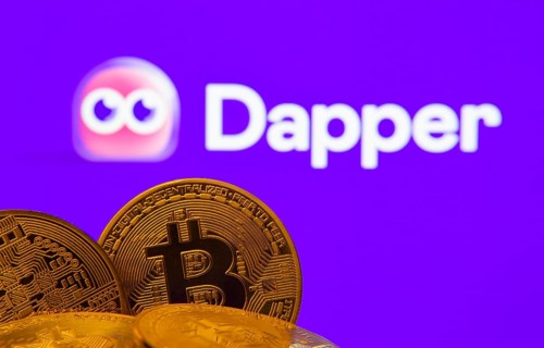 Dhaka, Bangladesh- 03 Oct 2025: Close-up of Bitcoin coins with the Dapper logo visible on a screen