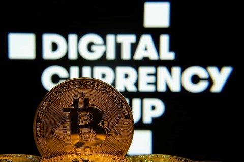 Dhaka, Bangladesh- 03 Oct 2025: Close-up of Bitcoin coins with the Digital currency group logo