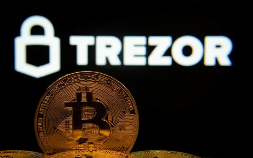 Dhaka, Bangladesh- 30 Sep 2025: Close-up of Bitcoin coins with the Trezor logo visible on a screen