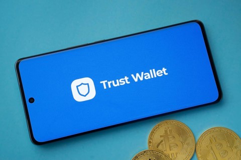 Dhaka, Bangladesh- 30 Sep 2025: Trust Wallet logo on smartphone screen near Bitcoin coin and QR