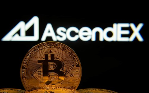 Dhaka, Bangladesh- 02 June 2025: Close-up of Bitcoin coins with the AscendEX logo visible on a