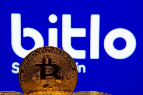 Dhaka, Bangladesh- 03 Sep 2025: Close-up of Bitcoin coins with the Bitlo logo visible on a screen