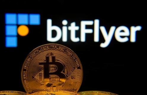 Dhaka, Bangladesh- 02 June 2025: Close-up of Bitcoin coins with the Bitflyer logo visible on a