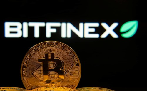 Dhaka, Bangladesh- 15 June 2025: Close-up of Bitcoin coins with the Bitfinex logo visible on a