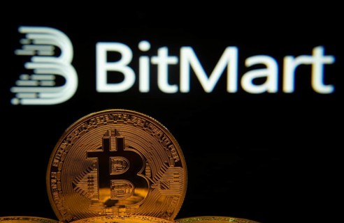 Dhaka, Bangladesh- 03 Sep 2025: Close-up of Bitcoin coins with the Bitmart logo visible on a screen