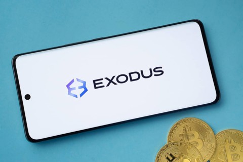 Dhaka, Bangladesh- 06 Sep 2025: Exodus logo on smartphone screen near Bitcoin coin and QR code on