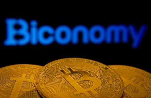 Dhaka, Bangladesh- 02 June 2025: Close-up of Bitcoin coins with the Biconomy logo visible on a