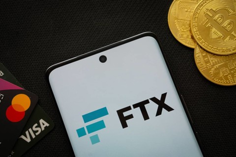 Dhaka, Bangladesh- 26 Aug 2025: Smartphone displaying FTX logo surrounded by Bitcoin coins and