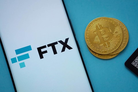 Dhaka, Bangladesh- 03 Sep 2025: FTX logo on smartphone screen near Bitcoin coin and QR code on blue