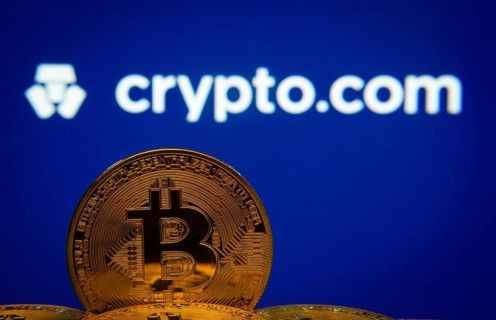 Dhaka, Bangladesh- 26 Aug 2025: Close-up of Bitcoin coins with the Crypto.com logo visible on a