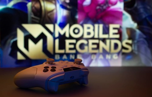 Dhaka, Bangladesh- 25 Aug 2025: A close-up of a white gamepad with Mobile Legends Bang Bang seen on