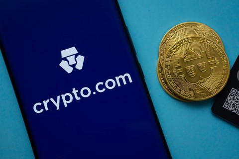 Dhaka, Bangladesh- 26 Aug 2025: Crypto.com logo on smartphone screen near Bitcoin coin and QR code