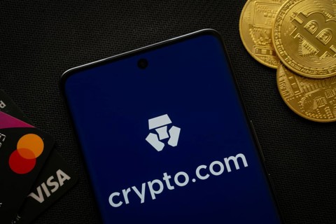 Dhaka, Bangladesh- 26 Aug 2025: Smartphone displaying Crypto.com logo surrounded by Bitcoin coins