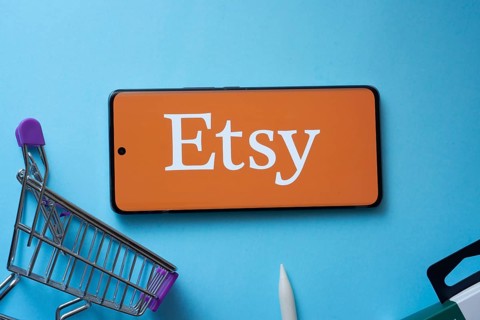 Dhaka, Bangladesh- 03 July 2025: Smartphone displaying Etsy logo with shopping cart on a blue