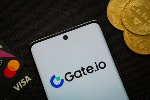 Dhaka, Bangladesh- 27 July 2025: Smartphone displaying Gate.io logo surrounded by Bitcoin coins and