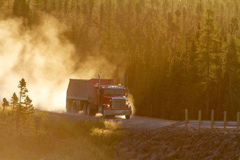 Transport truck driving on a dusty forest track, Province of Quebec, Canada, North America