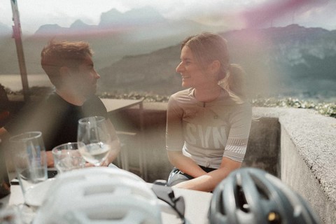 Young man taking a coffee break while riding his racing bike on Lake Garda. Sunny weather and dolce