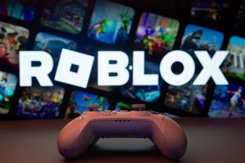 Dhaka, Bangladesh- 26 July 2025: A close-up of a white gamepad with The Roblox seen on screen in