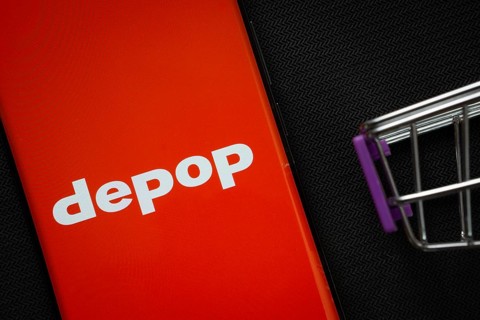 Dhaka, Bangladesh- 03 July 2025: A smartphone displaying the Depop logo next to a miniature