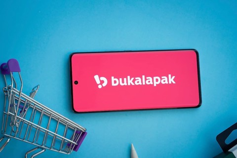 Dhaka, Bangladesh- 03 July 2025: Smartphone displaying Bukalapak logo with shopping cart on a blue
