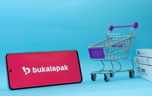 Dhaka, Bangladesh- 03 July 2025: Smartphone with Bukalapak logo next to a small shopping cart and