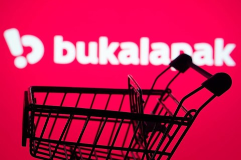 Dhaka, Bangladesh- 03 July 2025: Silhouette of a shopping cart in front of the Bukalapak logo,