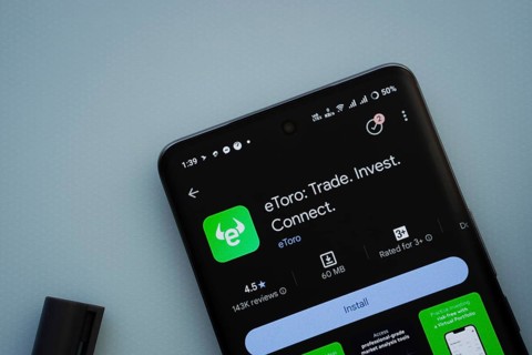 Dhaka, Bangladesh- 29 May 2025: On a blue surface, a smartphone displays the eToro app within the