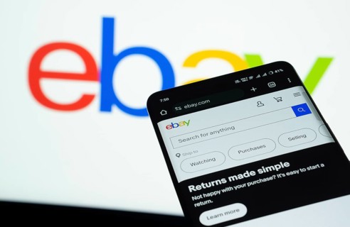 Dhaka, Bangladesh- 03 July 2025: Smartphone displaying eBay web interface against eBay logo