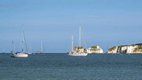 Boats on sea over Knoll Beach Studland, Poole, Dorset, England, United Kingdom