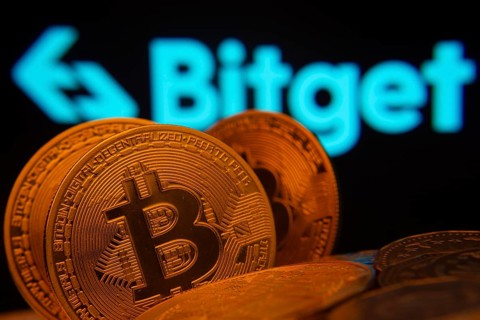 Dhaka, Bangladesh- 27 July 2025: Close-up of Bitcoin coins with the Bitget logo visible on a screen