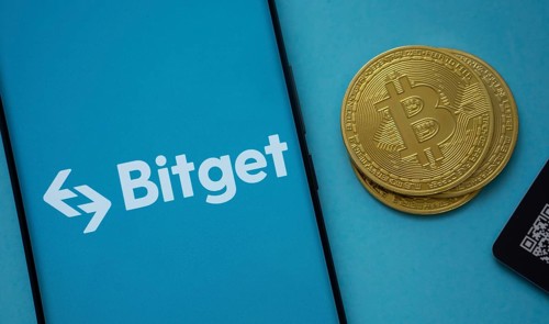 Dhaka, Bangladesh- 22 July 2025: Bitget logo on smartphone screen near Bitcoin coin and QR code on