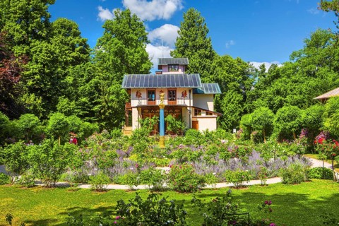 Rosarium with blooming roses in front of the Pompeian-Bavarian Casino on the Rose Island in Lake