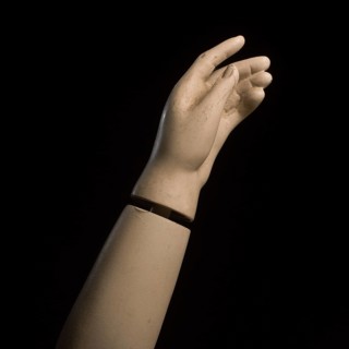 A detailed view of a mannequin hand with fingers slightly curled, creating a graceful pose against