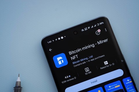 Dhaka, Bangladesh- 29 May 2025: On a blue surface, a smartphone displays the Bitcoin mining app