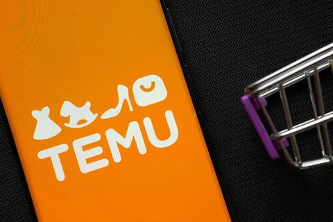 Dhaka, Bangladesh- 03 July 2025: A smartphone displaying the Temu logo next to a miniature shopping