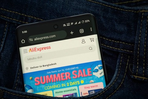 Dhaka, Bangladesh- 15 June 2025: A smartphone displaying the AliExpress web interface peeks out of