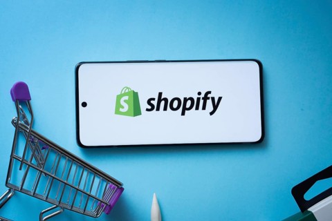 Dhaka, Bangladesh- 03 July 2025: Smartphone displaying Shopify logo with shopping cart on a blue