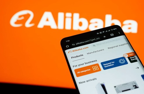 Dhaka, Bangladesh- 03 July 2025: Smartphone displaying Alibaba web interface against Alibaba logo