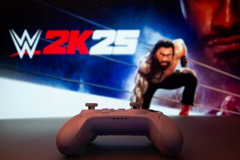 Dhaka, Bangladesh- 03 July 2025: A close-up of a white gamepad with The WWE 2K25 seen on screen in