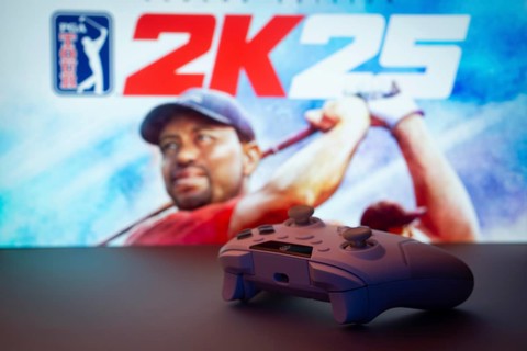 Dhaka, Bangladesh- 03 July 2025: A close-up of a white gamepad with The PGA TOUR 2K25 seen on
